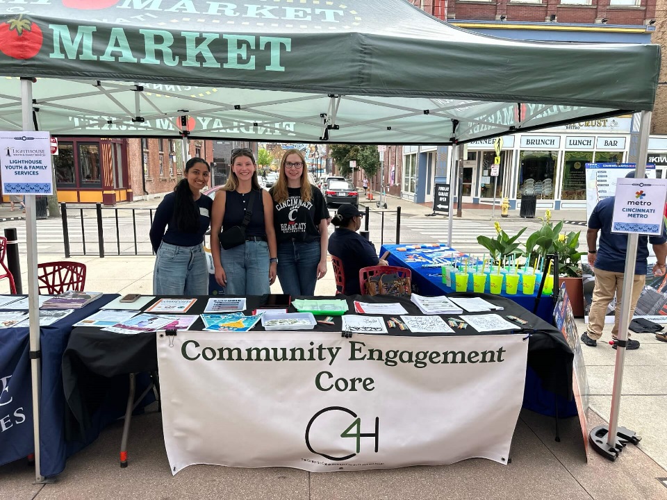 CEC faculty, staff, and student volunteer tabling at a community event