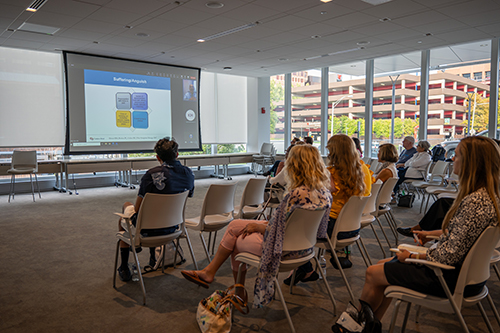 A group of cancer survivors listen to an educational talk.