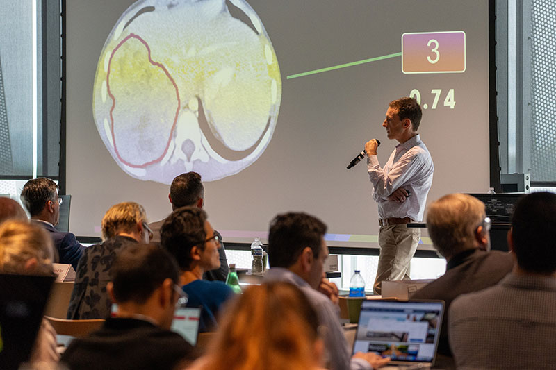 Speaker at the 10th Annual Charge Against Cancer event presents on the effects of AI on cancer research.