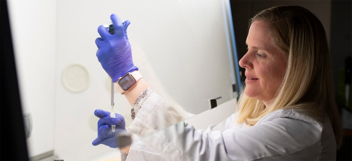 Joan Garrett, PhD in lab doing research.