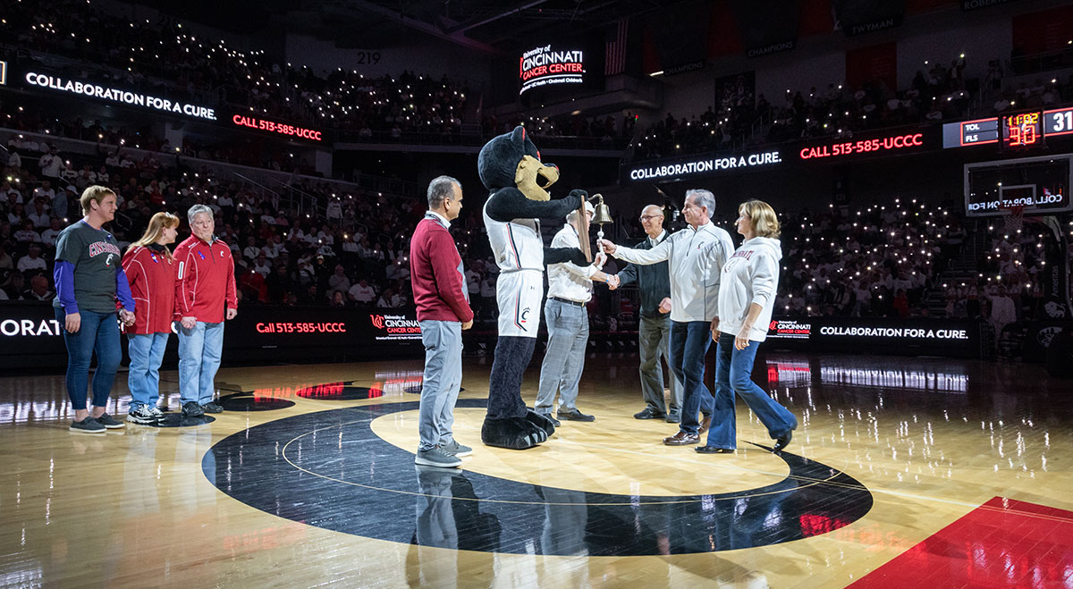 Patient rings the Cancer Bell at UC Basketball Game Ceremony