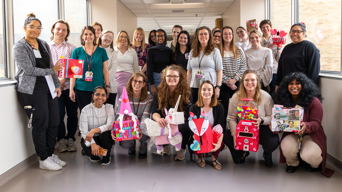 Clinical Trials Office staff pose with Valentine's Day boxes they created as part of a team building exercise. 