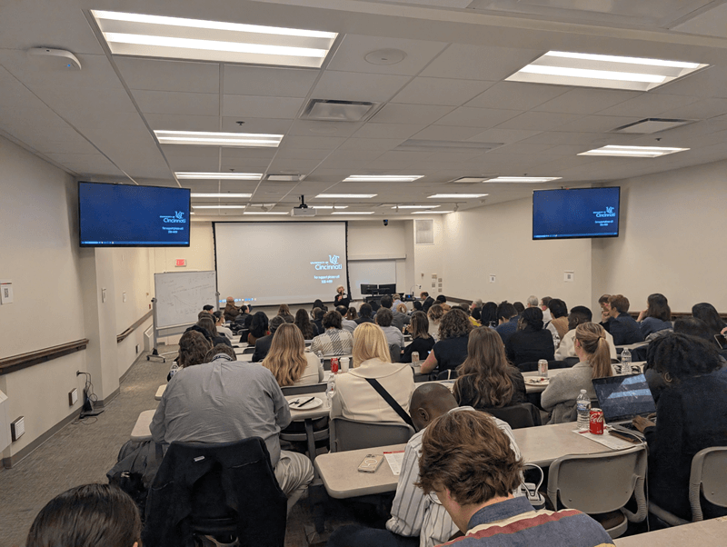 people in a classroom listening to a presentation