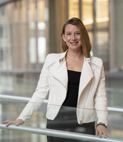 Headshot of woman standing by railing
