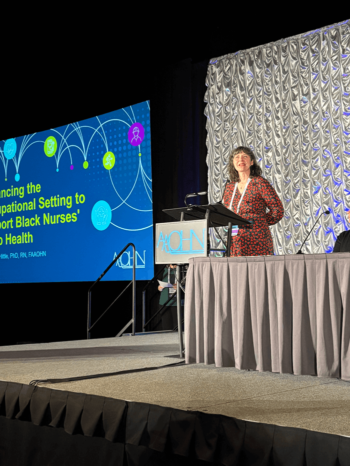 person on stage presenting