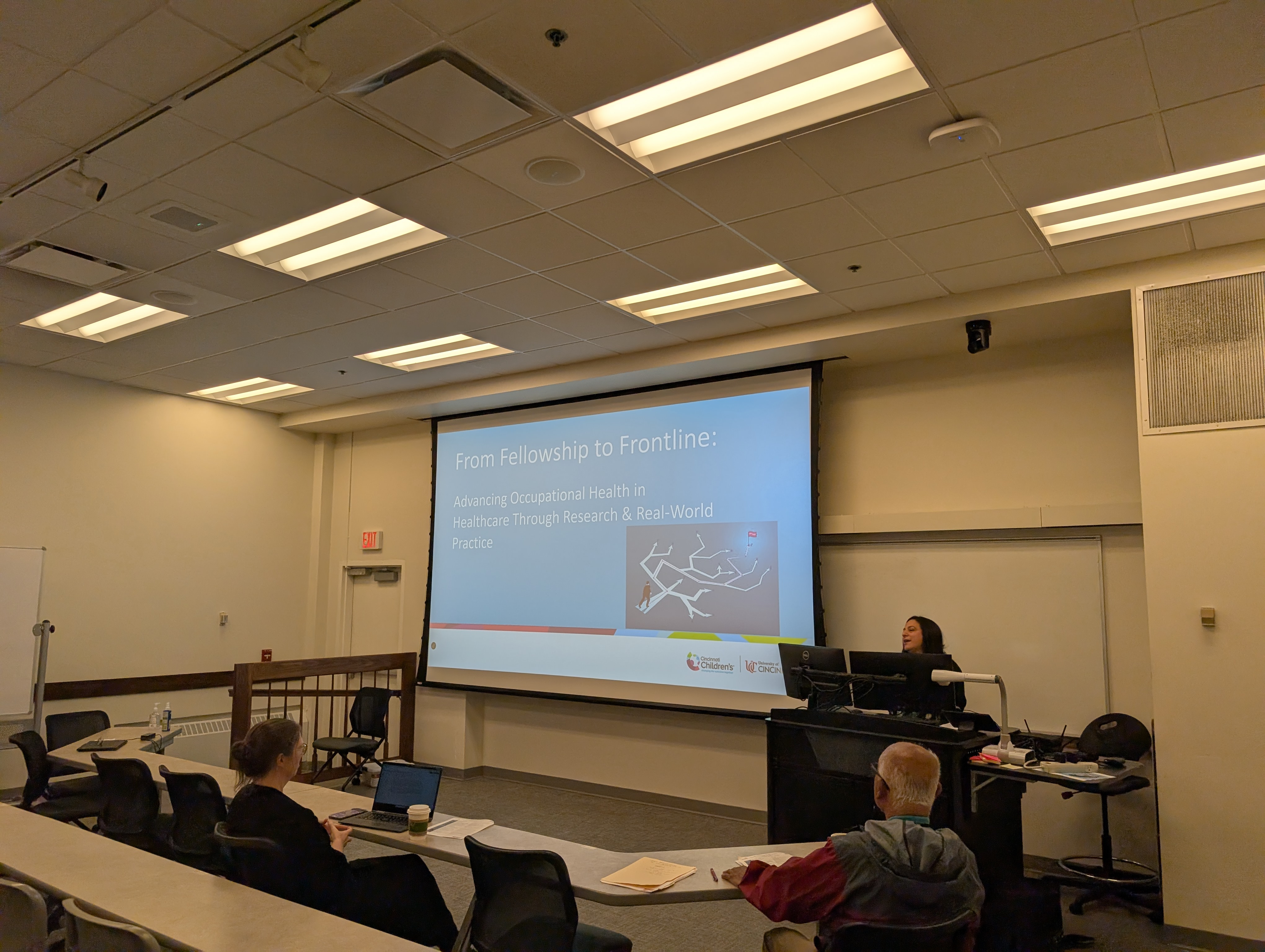 person presenting at a podium