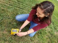 mph-student-devin-knutson-using-xrf-equipment-to-measure-lead-levels-in-soil