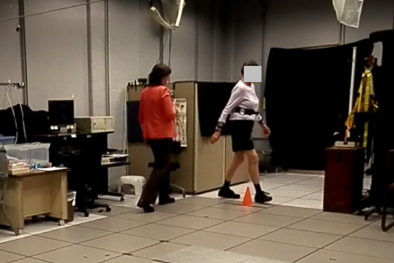 A person walking around a cone in a timed 'up and go' test