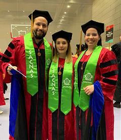 three graduates standing