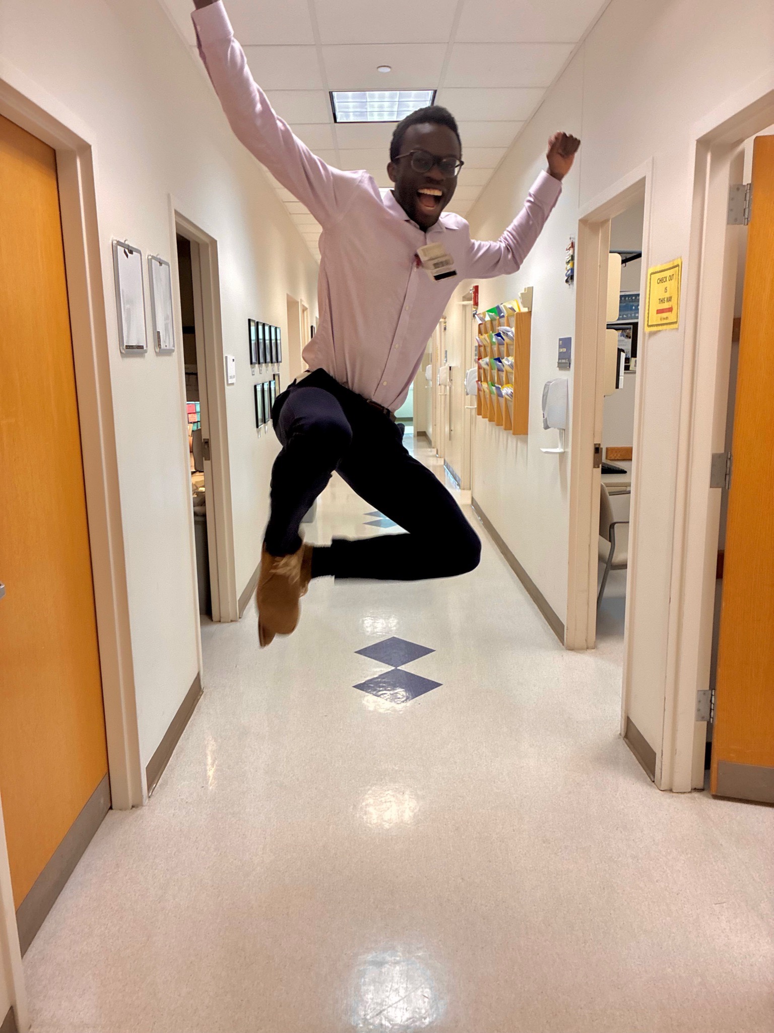 A Med-Peds Resident jumping in the air and clicking his heels in the clinic hallway.