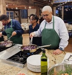 Image from Turner Farm teaching kitchen three people cooking a healthy meal