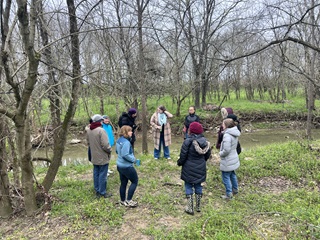 group of people in winter gear preparing for a winter forest therapy hike