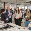 A group of people mingling in a kitchen