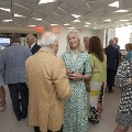 Groups of people mingling and enjoying drinks and appetizers