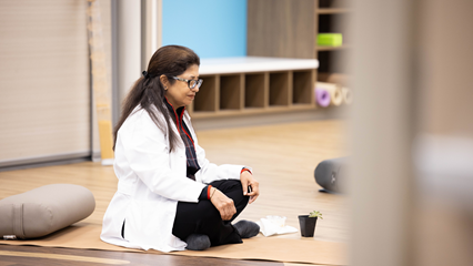 a seated person with their eyes closed in a mindfulness class