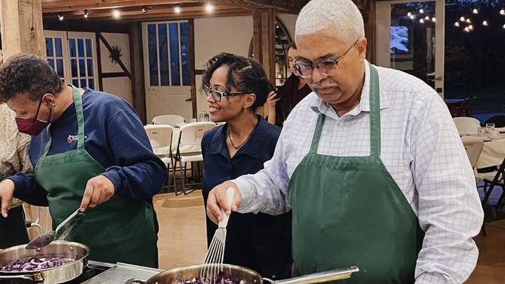 Pamela Sharpe helping participants at a teaching kitchen event