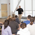 Man lecturing group sitting on the floor