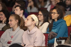 Women watch speaker