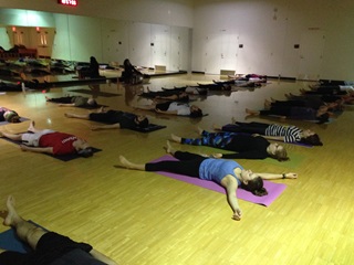 group of people practicing yoga in a classroom