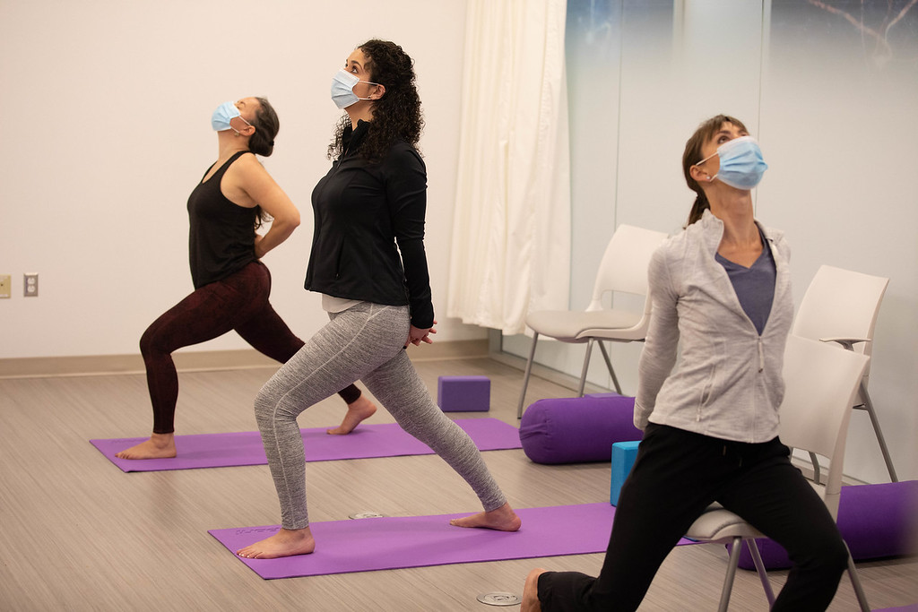 three women practicing yoga