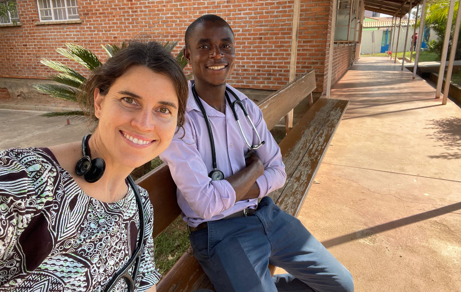 Man and woman sitting on bench smiling