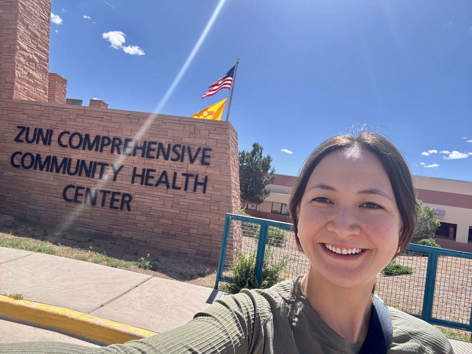 Woman standing in front of sign