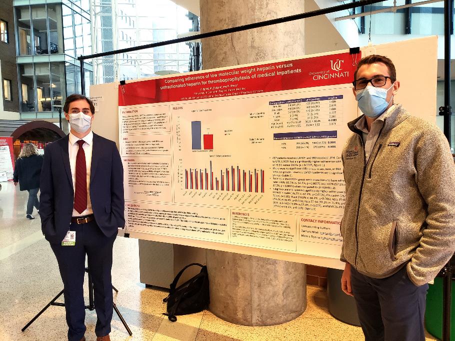 Photo of Two Residents Presenting a Research Poster