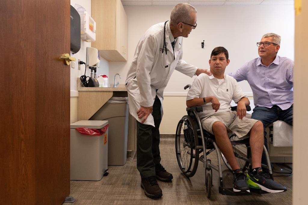 Patient in wheelchair seeing doctor
