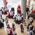 An aerial photo of a group of white coat clad students serving themselves food
