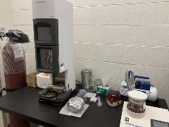 Image of CASB work area for preparing Cryo-EM grids using a Vitrobot plunge freezing device. Requisite hand tools, ethane gas cylinder and grid glow-discharging device are also shown.