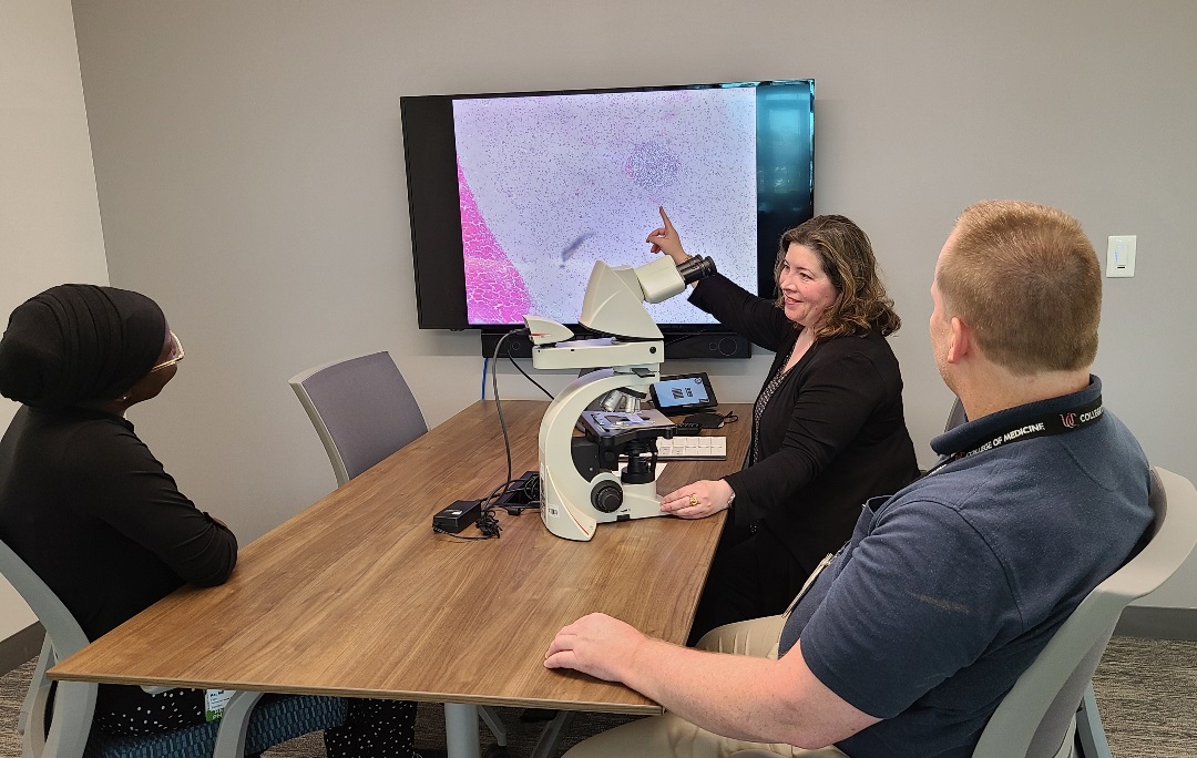 Image of Dr. Laib teaching Microscopy to resident